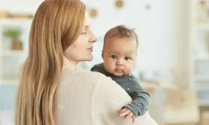 Mama tuli 4 miesięczne dziecko odchyla głowę do tyłu, patrząc z zaciekawieniem.